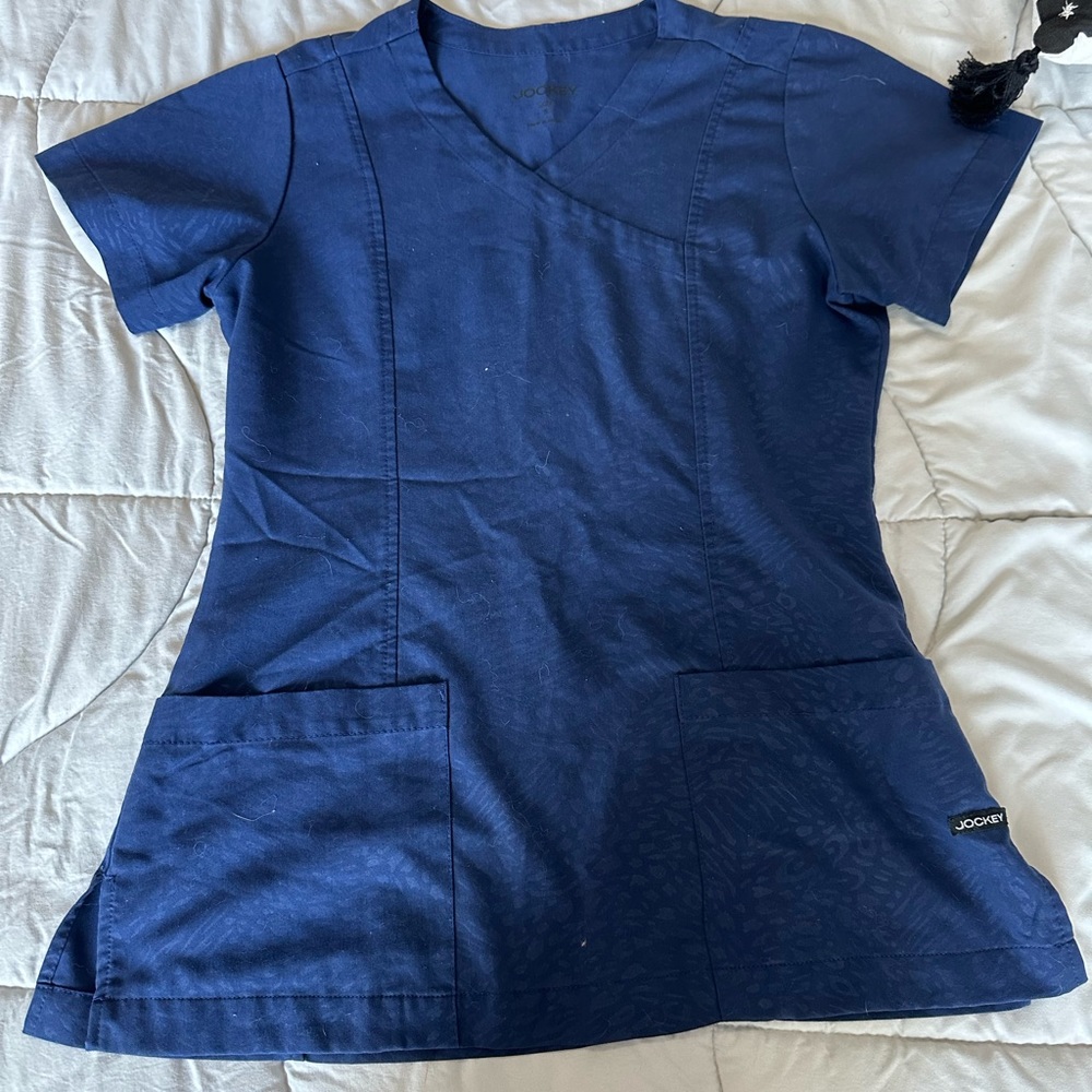 Navy jockey scrub top with pattern.